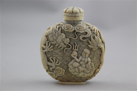 A Chinese ivory dragon and luohan snuff bottle, 1800-1850, 6.2cm